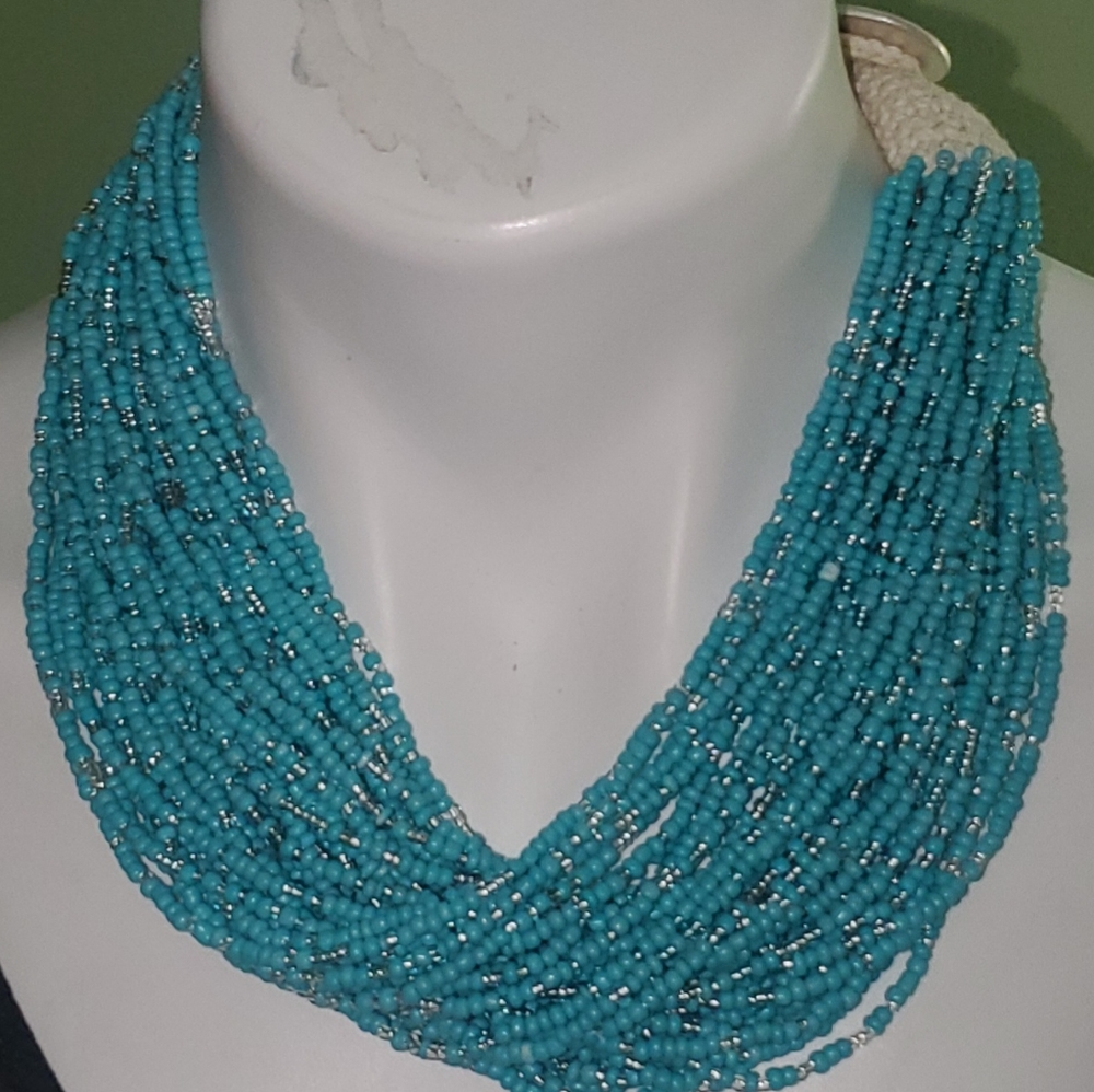 Necklace w/ multiple strands of tiny turquoise beads. Lucky brand